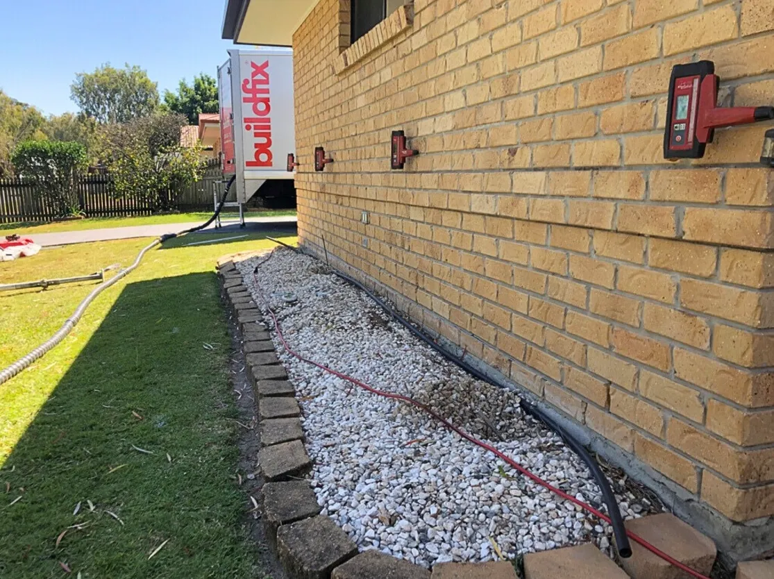 Buildfix GeoPoly injection equipment repairing foundation subsidence in brick wall.
